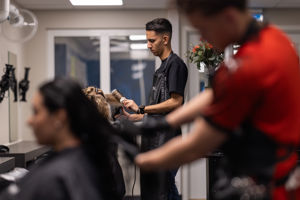 a man cutting a woman's hair