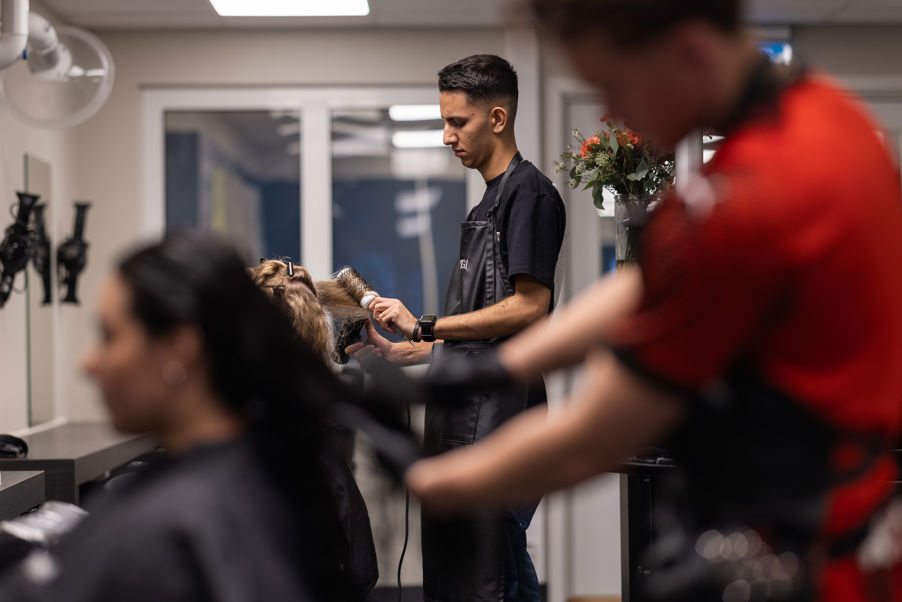 a man cutting a woman's hair