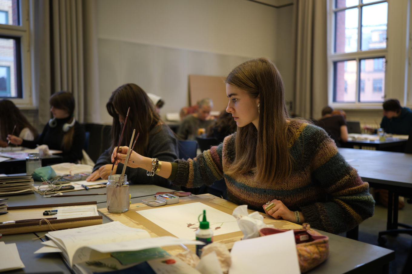 en person som sitter ved et bord en person som sitter ved et bord